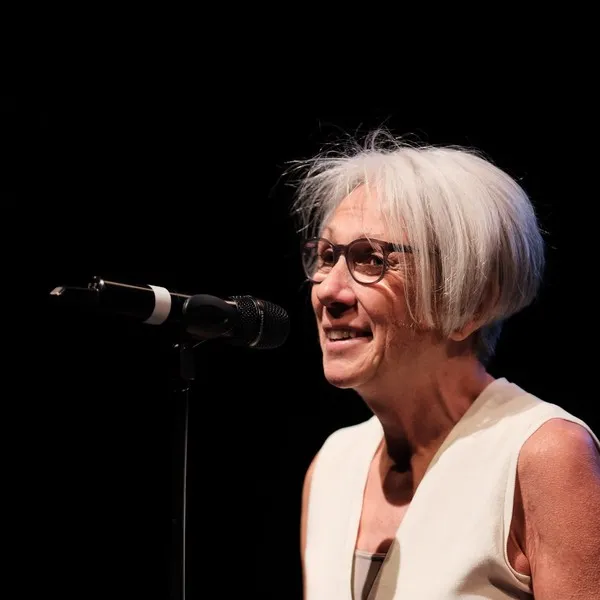 Jo Eades performing at a microphone